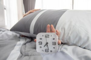 freepicdownloader.com woman sleep bed turns off alarm clock wake up morning selective focus normal