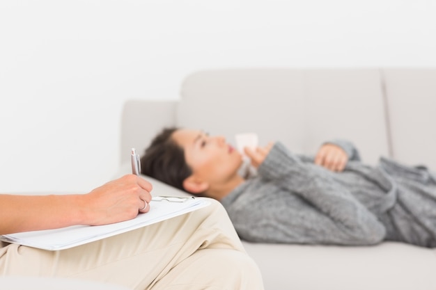 freepicdownloader.com therapist taking notes her crying patient sofa normal